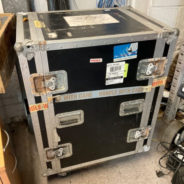 Large, used flight case with airline stickers and handle.