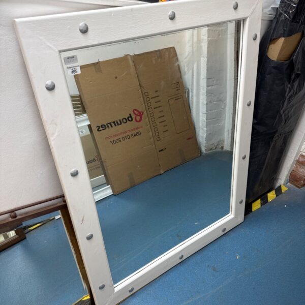 Large painted wood mirror with decorative stud details.