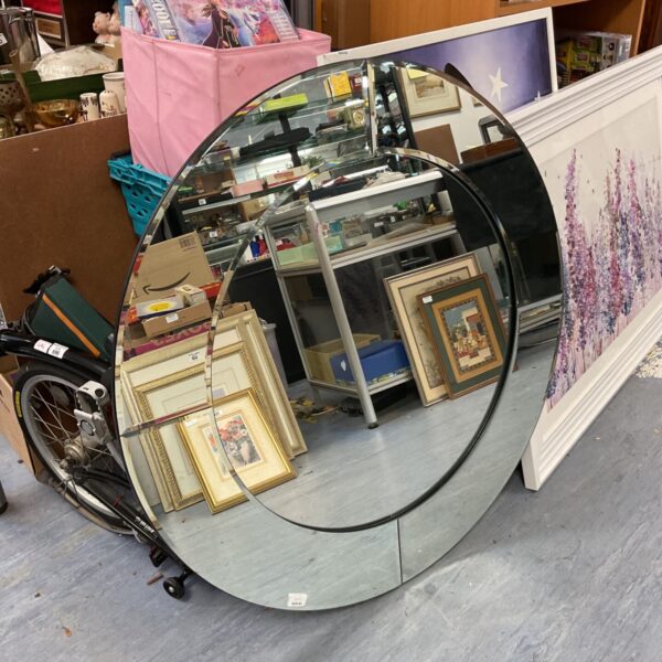 Large round bevelled edge mirror, a vintage home decor item.
