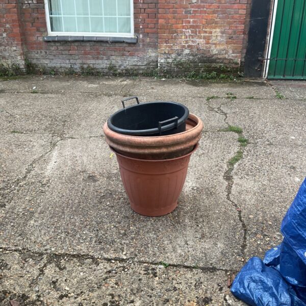 Large terracotta garden pot with weathered finish.