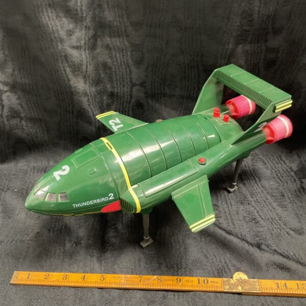 Large green Thunderbird 2 toy viewed from front angle with landing legs extended