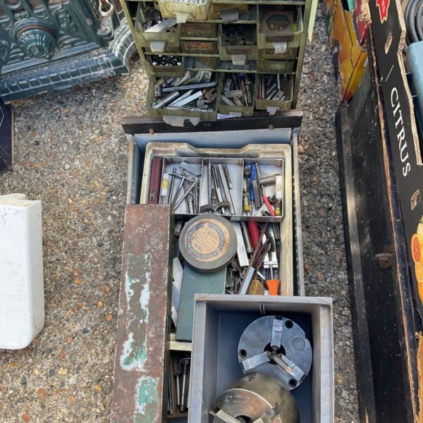 Overview of vintage lathe tool cabinet with drawers full of tools.