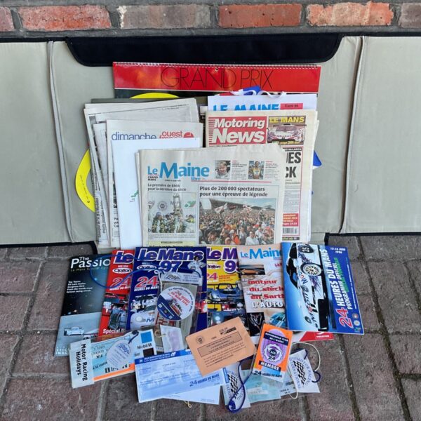 Le Mans 24 Hours ephemera with newspapers, race programmes, magazines and tickets displayed on grey board