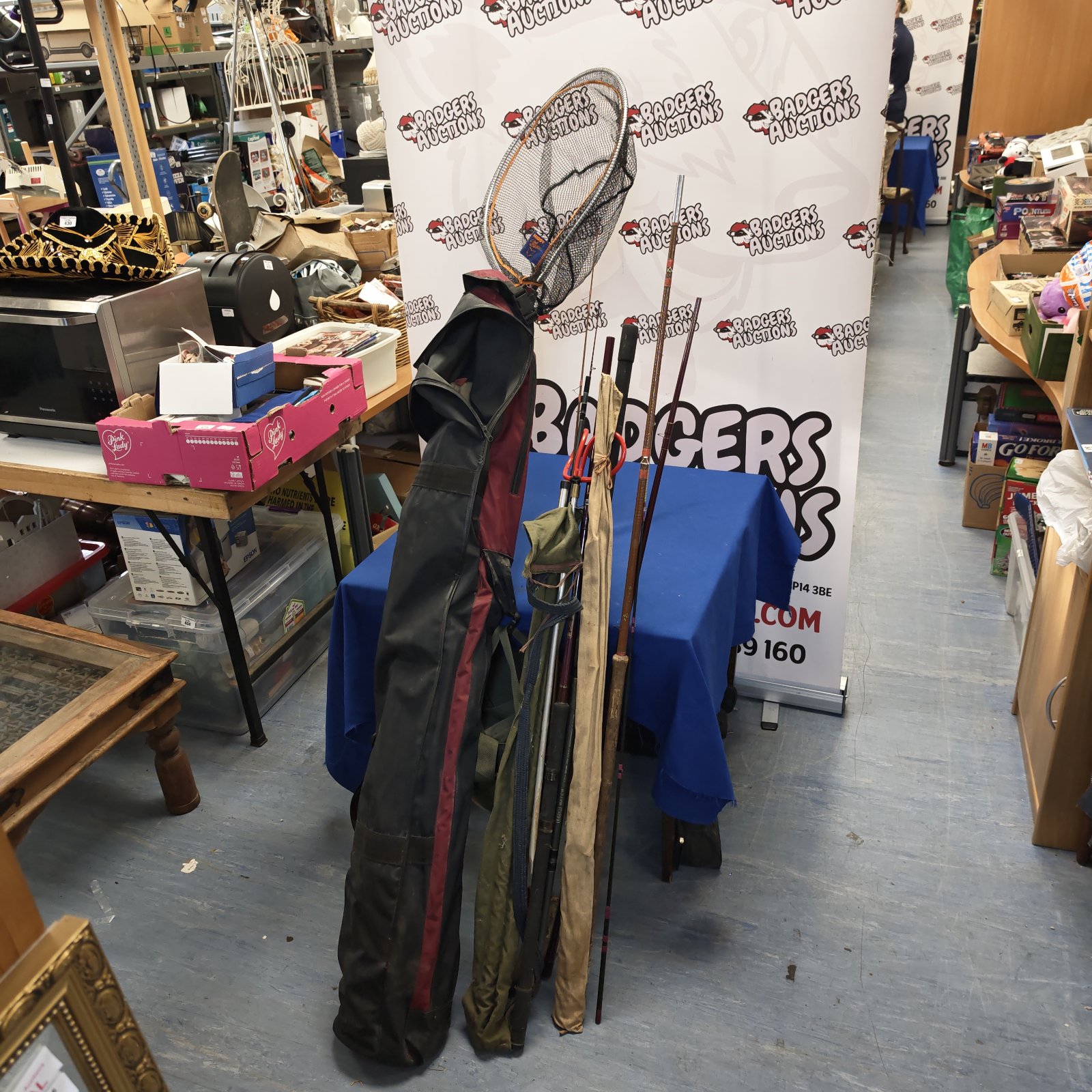 Fishing rods and net in a Leeds bag, angling equipment.