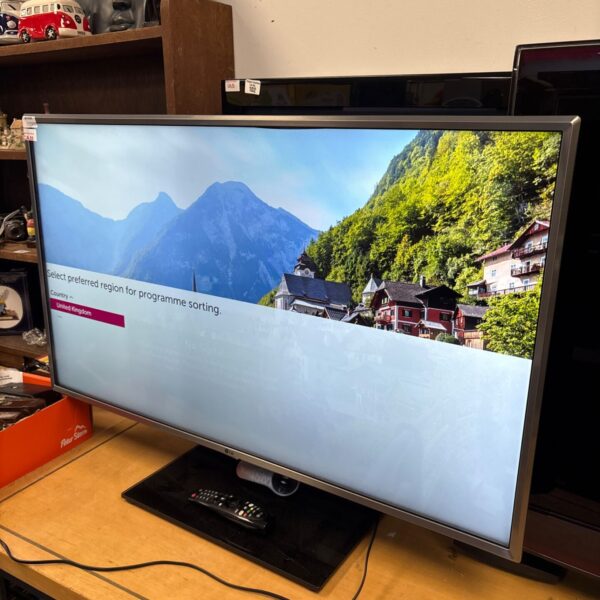 LG 43 inch 43UK6950PLB television on wooden surface showing setup screen