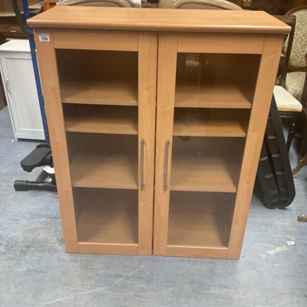 Vintage light oak glazed display cabinet with two doors.