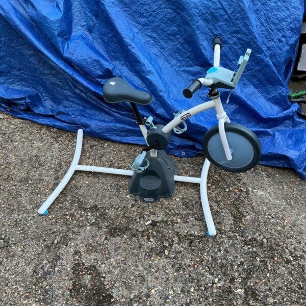 Bright Little Tikes exercise bike for children's indoor activity.