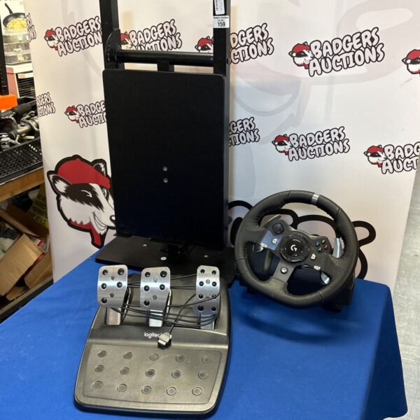 Logitech G920 racing wheel and pedals for PC gaming setup.
