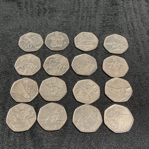 Sixteen 2011 London Olympics 50p coins arranged in four rows on dark fabric