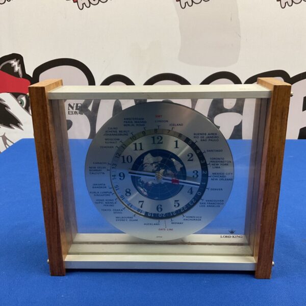 Front view of vintage Lord King world time desk clock with globe dial
