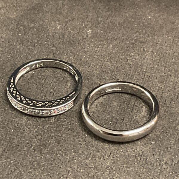 Two 925 Silver Rings One band ring other set with clear stones Sizes N