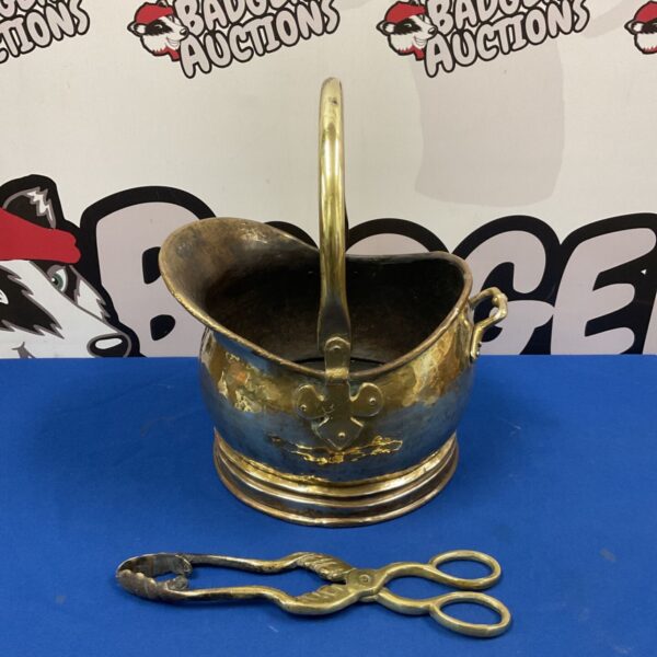 Small vintage brass helmet coal bucket with pair of tongs