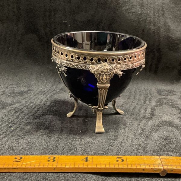 antique three footed silver salt featuring putti heads with cobalt blue glass liner with 18th Century Paris Hallmark Louis XV. 81.79g
