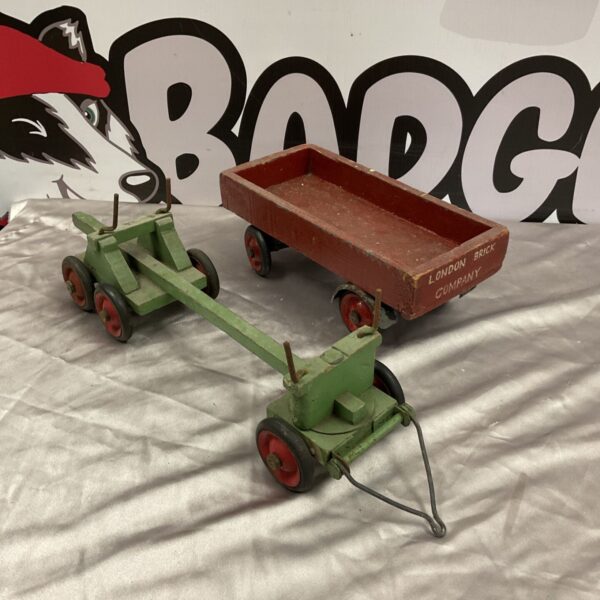 Two vintage wooden toy trailers, including London brick company and logging trailer