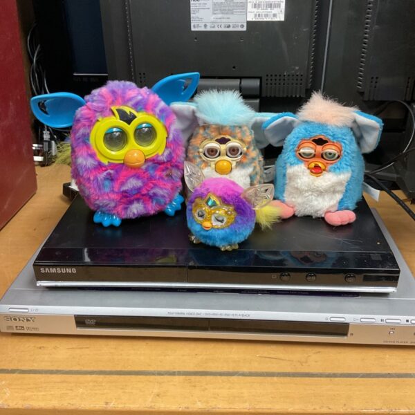 Two DVD players inc Sony with a box of furby interactive toys