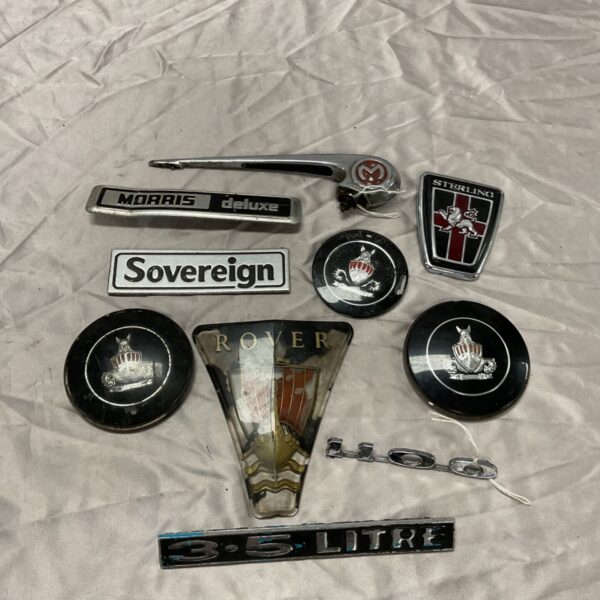 Box of car badges including rover