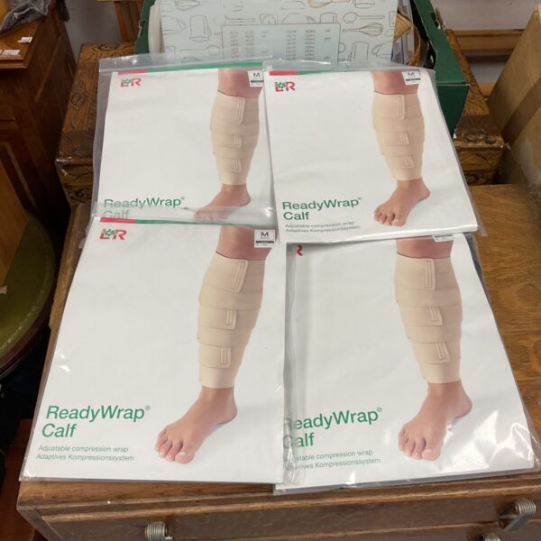 Four sealed L&R ReadyWrap Calf compression wraps, size medium, in packaging