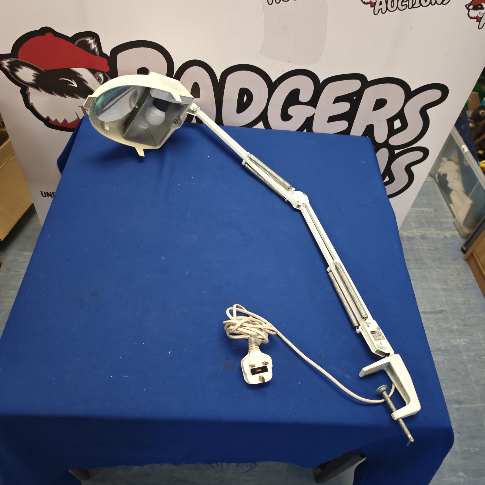 Vintage magnifying desk lamp for workshop use.