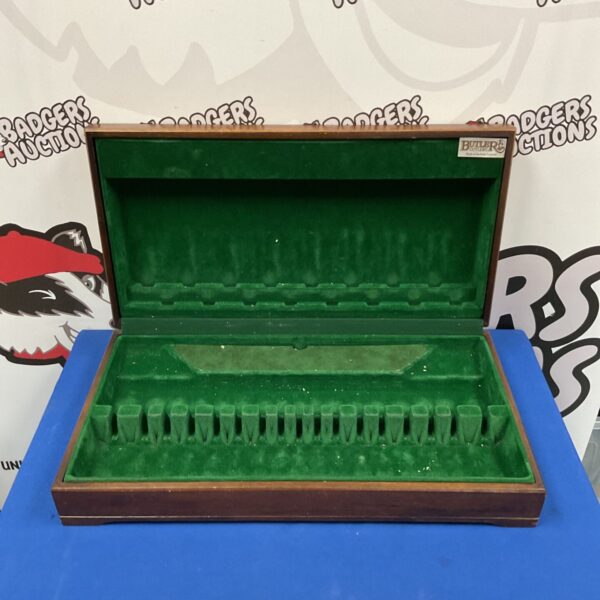 Open antique mahogany cutlery case displaying green felt lining.