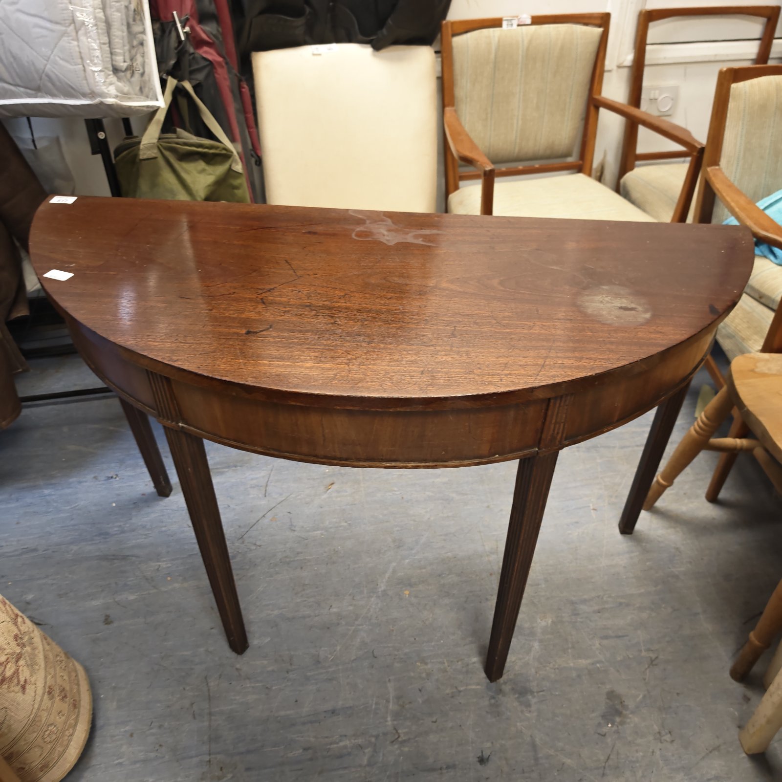 Antique mahogany demi hall table with tapered legs.