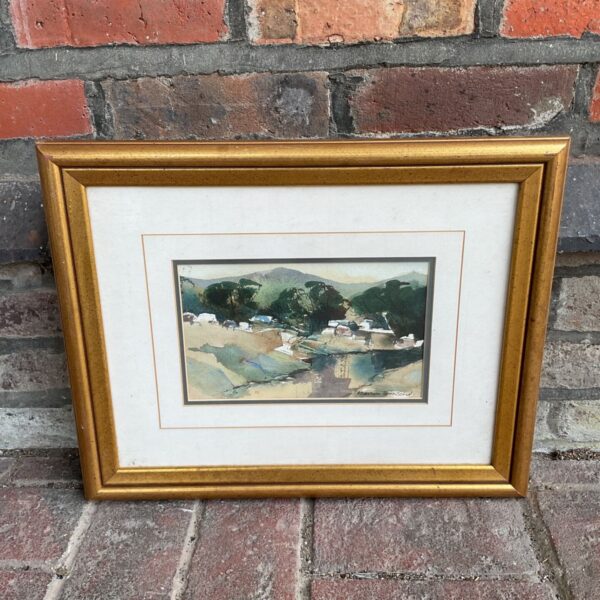 Gilt framed watercolour by Marion Townsend of a country valley village scene