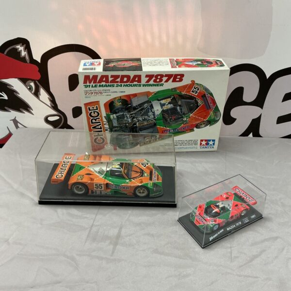 Tamiya Mazda 787B Le Mans 1991 kit box beside display models in acrylic cases