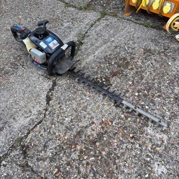 Used McAllister MHTP245-3 hedge trimmer for garden maintenance.