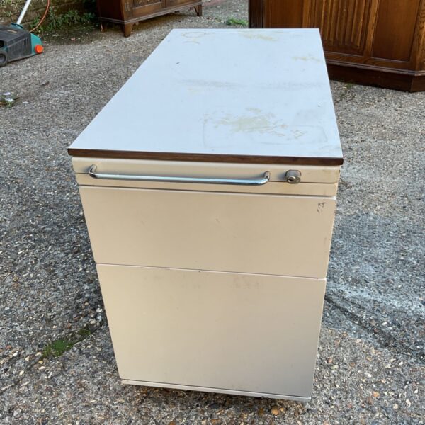 Vintage metal filing cabinet with three drawers and stationery section.