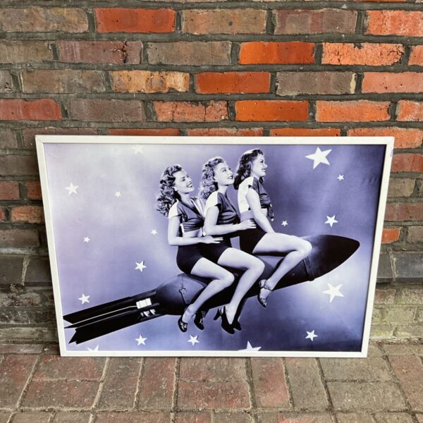 Vintage mid-century print of women on a rocket ship.