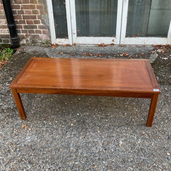 Vintage mid-century Scandinavian coffee table with warm wood finish.