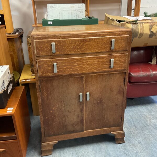 Mid-century wooden two drawer cabinet with scrolled metal handles and cupboards