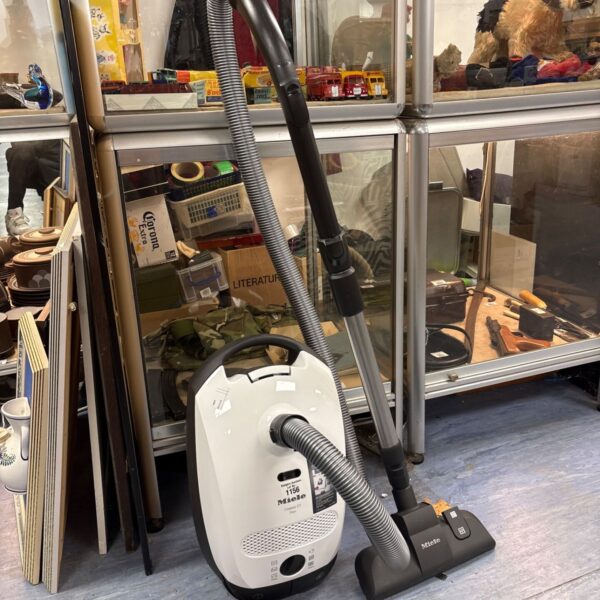 White Miele Classic C1 Flex cylinder vacuum with grey hose and floor head