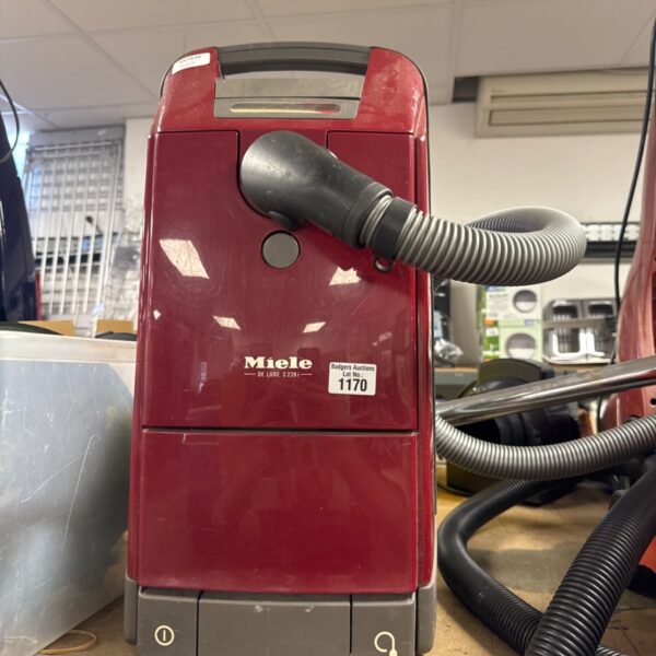 Vintage Miele de luxe S 228 I vacuum cleaner with hose attached.