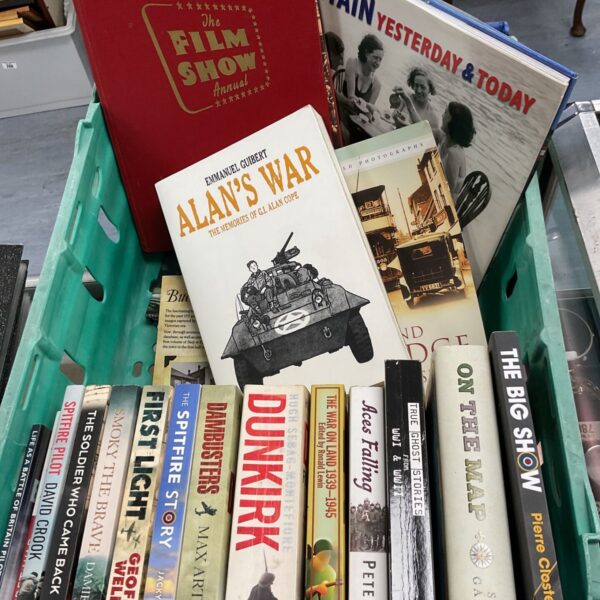 Vintage crate filled with a collection of military history books.