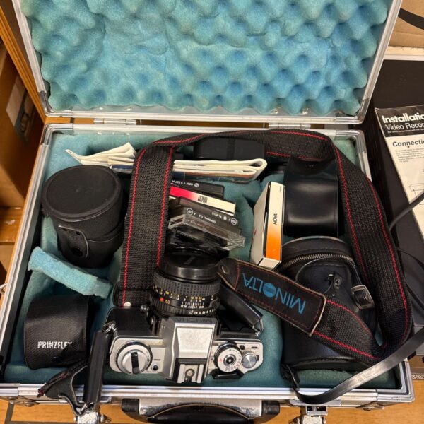 Minolta XG-M camera with leather cases and filters in aluminium carrying case