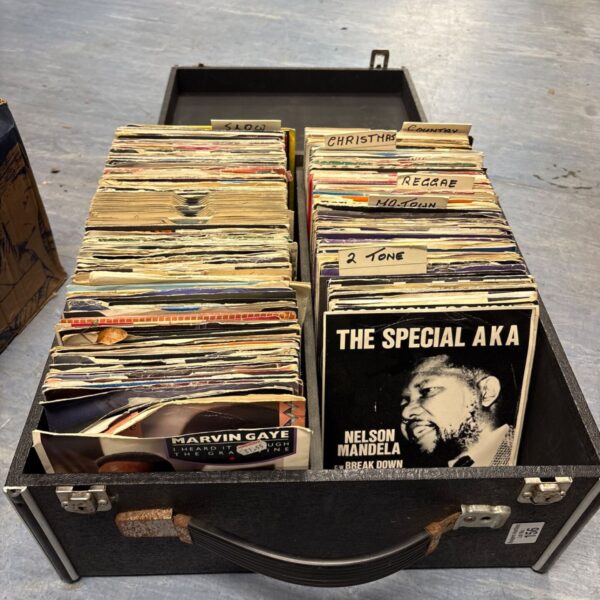 Carry case of mixed 7 inch vinyl singles with genre dividers and sleeves