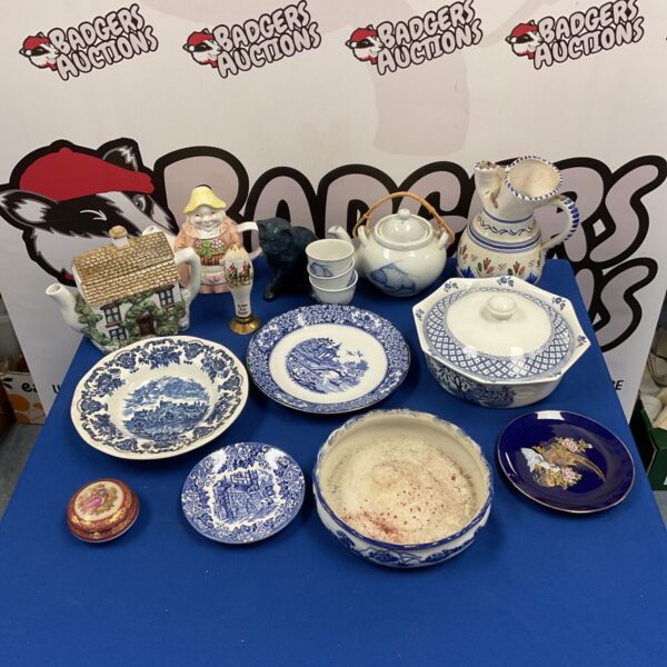 Mixed lot of blue and white china plates, bowls and teapot on blue cloth