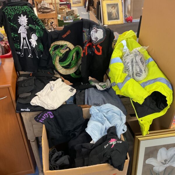 Mixed box of clothing with Dragon Ball Z and Rick and Morty t-shirts and hi-vis jacket