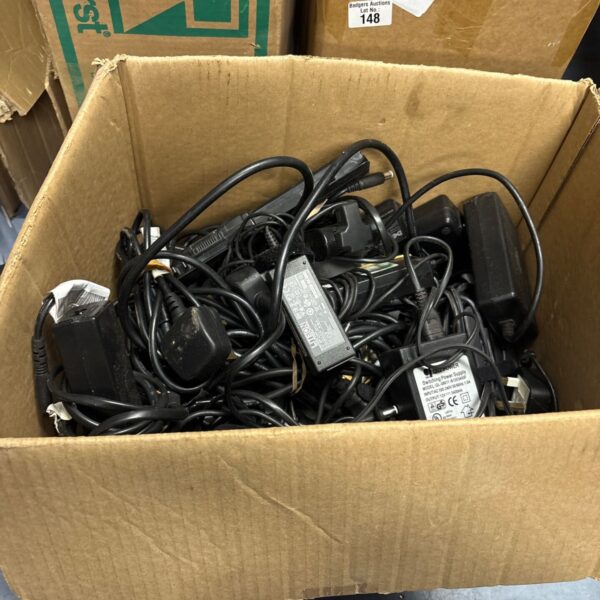 Mixed lot of chargers and power supplies for various electronics.