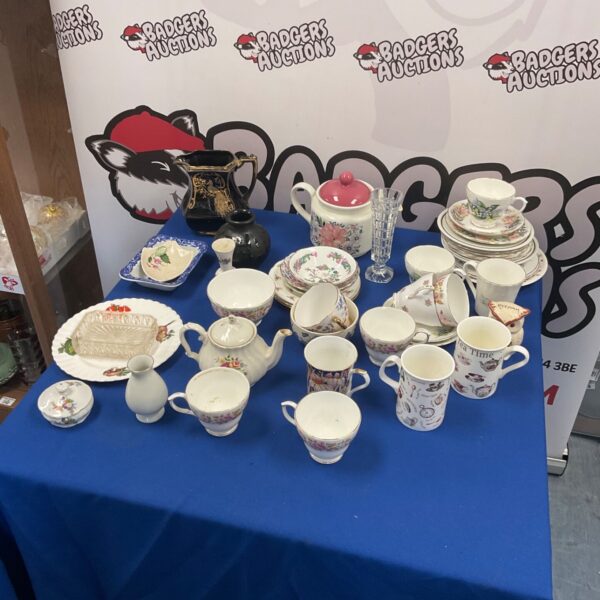 Vintage mixed china collection including Duchess china pieces on display.
