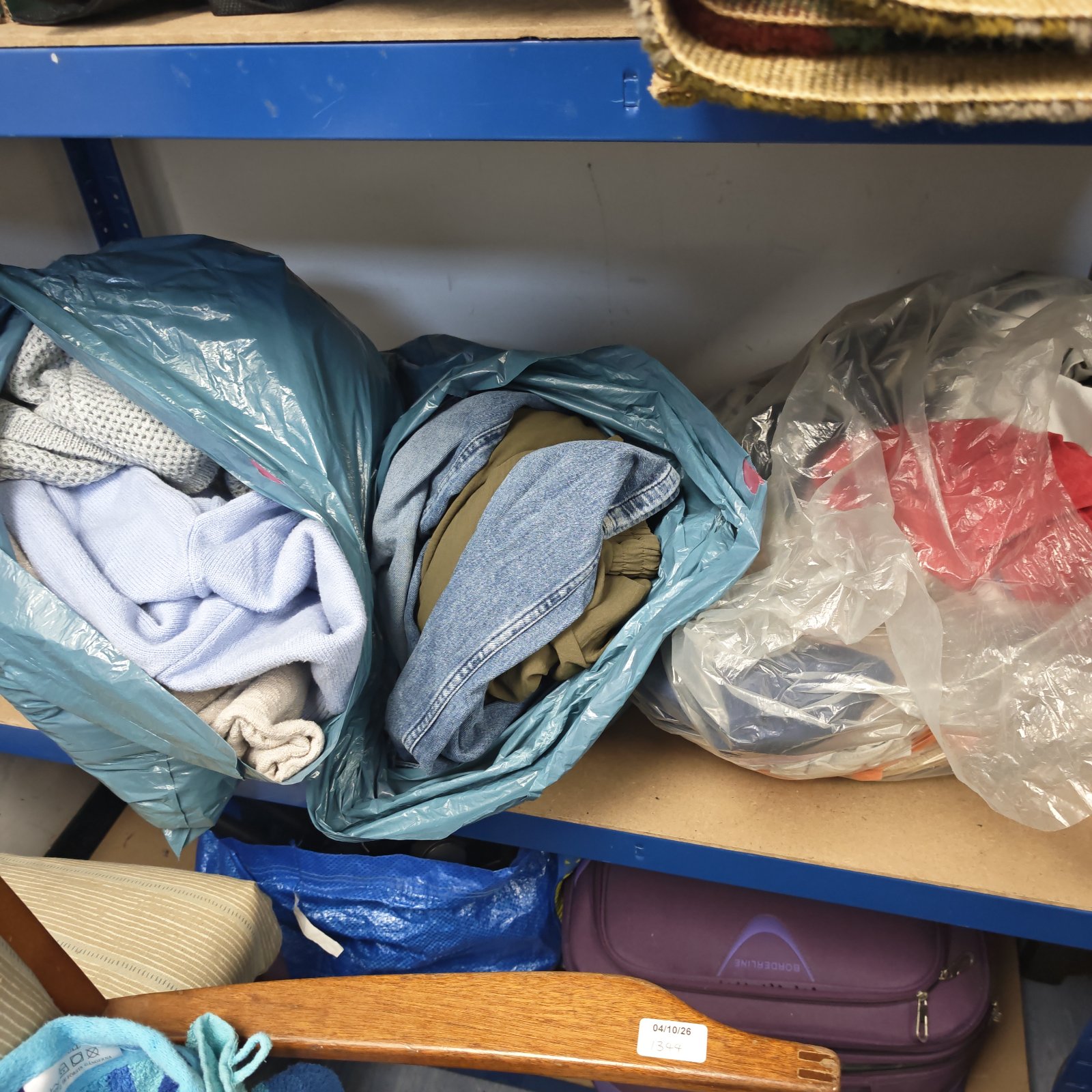 Bags of mixed clothing lot with assorted apparel.