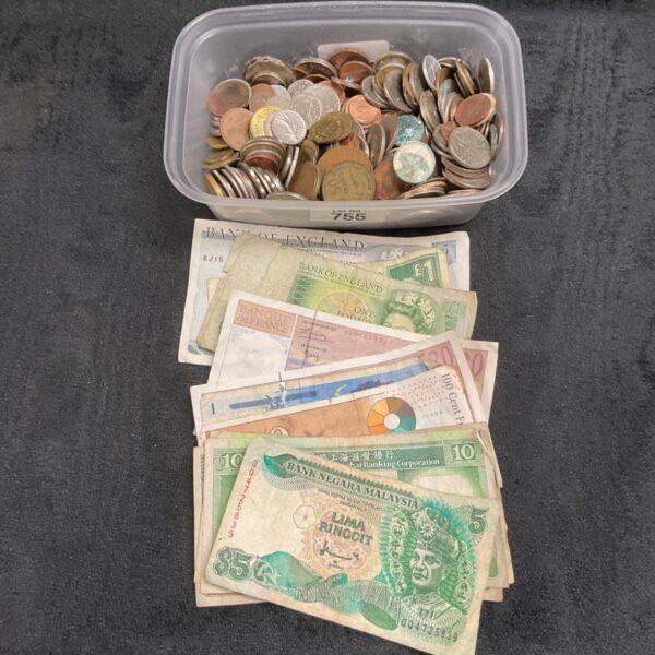 Mixed lot of coins and banknotes from various countries for collectors.