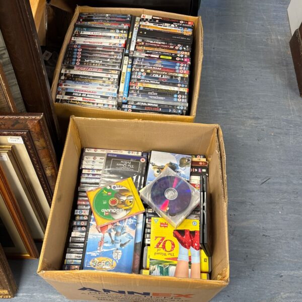 Two large boxes of mixed DVDs and CDs with film titles visible