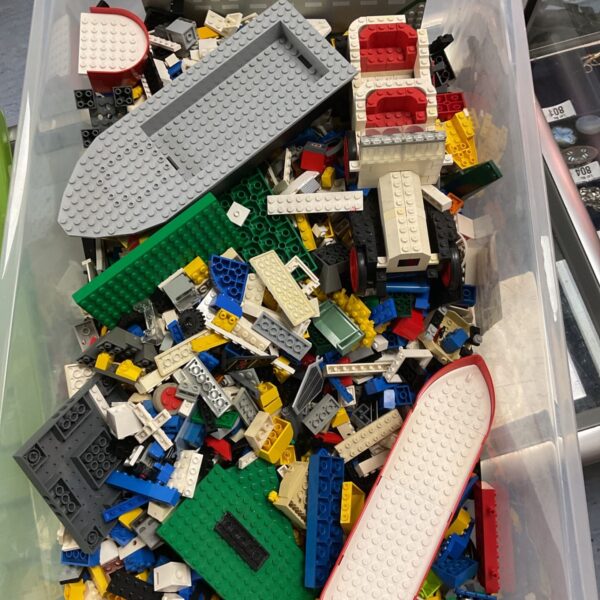 Crate filled with loose mixed LEGO bricks and baseplates in various colours