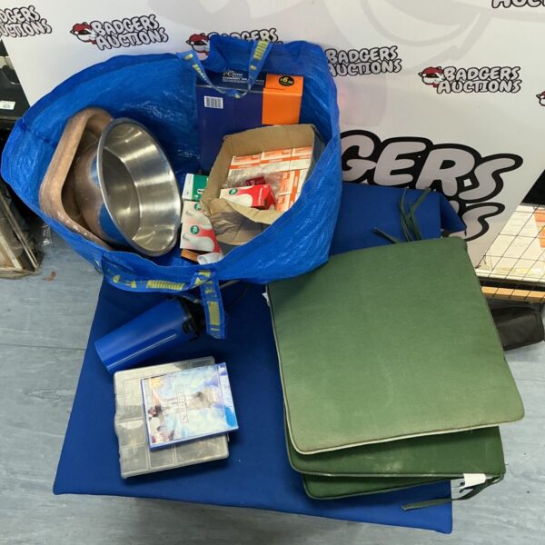 Mixed lot of household items at auction, including lightbulbs and a PS4 game.