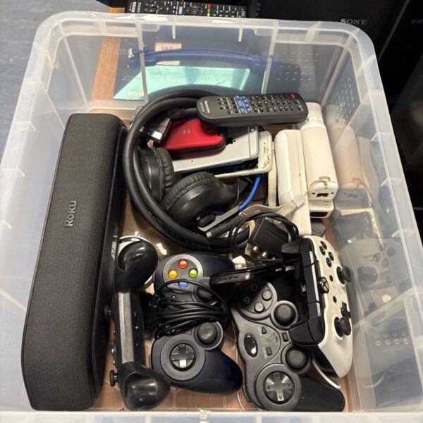 Mixed lot of vintage game controllers and a Roku speaker system.