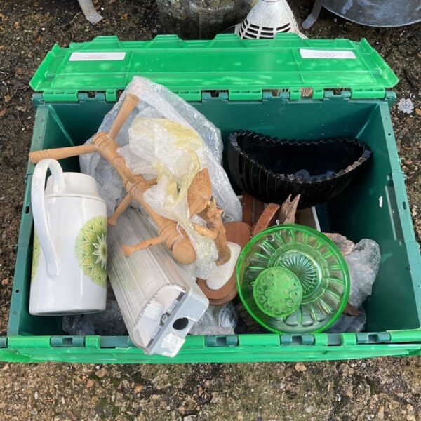 Green crate of mixed ceramics, green glass bowl and wooden figure
