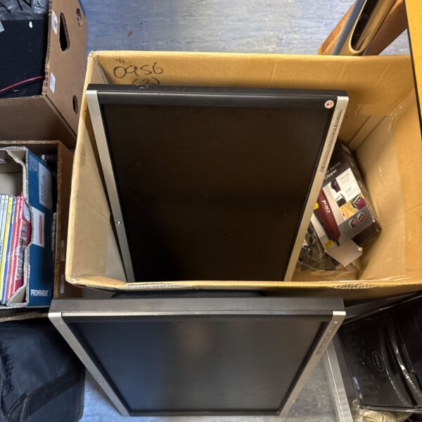 Cardboard box holding two monitor screens and a Wahl trimmer lot