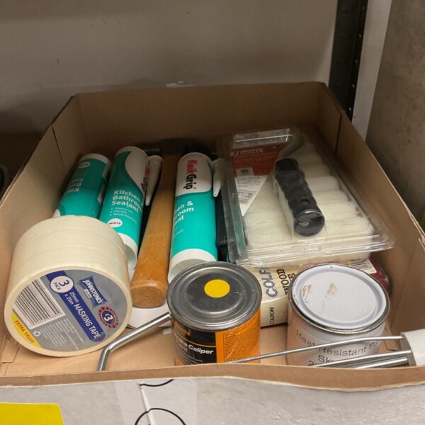Tray of mixed paint items with masking tape, sealant tubes and mini roller set