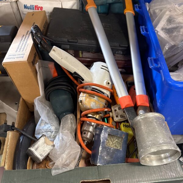 Tray of mixed power and garden tools for DIY projects.